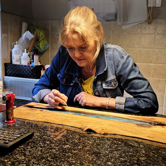 Mikki creating resin and wood art